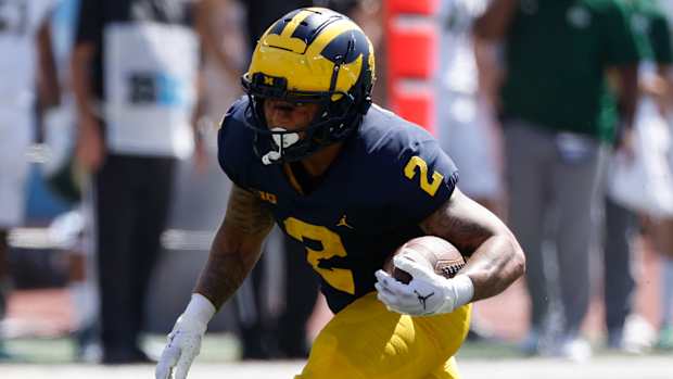 Michigan Wolverines running back Blake Corum on a rushing attempt during a college football game in the Big Ten.